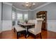 Dining room boasts elegant lighting, wainscoting, and a large window for plenty of natural light at 210 Creekside Overlook, Hiram, GA 30141