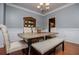 Cozy dining room features a farmhouse table with stylish seating and a classic china cabinet at 210 Creekside Overlook, Hiram, GA 30141