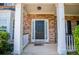 Elegant front entrance with a classic black door, brick facade, and white trim accents at 210 Creekside Overlook, Hiram, GA 30141