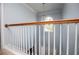 Hallway featuring wooden railing and view of main level and entry door at 210 Creekside Overlook, Hiram, GA 30141