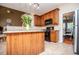 Open kitchen with cabinets, countertops, black oven, stainless steel fridge, and doorway to a dining room at 210 Creekside Overlook, Hiram, GA 30141