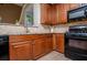Kitchen area featuring granite countertops, wooden cabinets, and stainless steel appliances at 210 Creekside Overlook, Hiram, GA 30141