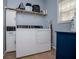 Laundry room with washer, dryer, cabinets and shelves at 210 Creekside Overlook, Hiram, GA 30141