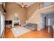 Open-concept living room with fireplace and hardwood floors, adjacent to staircase and entry at 210 Creekside Overlook, Hiram, GA 30141