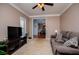 Comfortable living room with plush seating, soft carpet, and open access to the dining area at 210 Creekside Overlook, Hiram, GA 30141