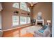 Inviting living room boasts a fireplace, hardwood floors, and an abundance of natural light at 210 Creekside Overlook, Hiram, GA 30141
