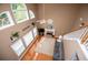 Aerial view of a living room featuring a fireplace, hardwood floors, and many windows at 210 Creekside Overlook, Hiram, GA 30141