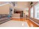 Open concept living room leads to kitchen and dining area, with hardwood floors and natural light at 210 Creekside Overlook, Hiram, GA 30141