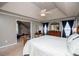 Bright main bedroom features a king-size bed, tray ceiling, and adjacent seating area at 210 Creekside Overlook, Hiram, GA 30141