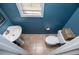 Powder room featuring tile flooring, toilet with decorative basket, and a stylish pedestal sink at 210 Creekside Overlook, Hiram, GA 30141
