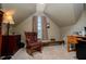 Attic room featuring rocking chair and desk area near window at 210 Creekside Overlook, Hiram, GA 30141