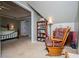Cozy sitting room adjacent to the main bedroom features a rocking chair and built-in bookcase at 210 Creekside Overlook, Hiram, GA 30141