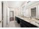 Spacious bathroom featuring dual sinks with granite countertops and a large mirror at 3167 Bay View Dr, Jonesboro, GA 30236