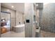 Beautifully appointed bathroom with tiled floors and walls, soaker tub, and enclosed shower at 3167 Bay View Dr, Jonesboro, GA 30236