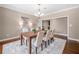 Formal dining room with hardwood floors, chandelier, and seating for six at 3167 Bay View Dr, Jonesboro, GA 30236