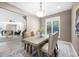 Bright dining room features a modern chandelier and a view of the living room and staircase at 3167 Bay View Dr, Jonesboro, GA 30236