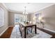 Well-lit dining room featuring hardwood floors, chandelier, and sliding glass doors at 3167 Bay View Dr, Jonesboro, GA 30236
