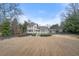 Expansive view of the home's rear exterior showcasing a large lawn and multi-level deck at 3167 Bay View Dr, Jonesboro, GA 30236