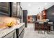 An open kitchen with custom cabinets, a large marble countertop, and stainless steel appliances at 3167 Bay View Dr, Jonesboro, GA 30236