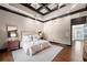 Comfortable main bedroom with ceiling fan, hardwood floors, coffered ceiling, and entry to a personal bathroom at 3167 Bay View Dr, Jonesboro, GA 30236