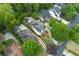 A high-angle view of luxury homes with manicured lawns and driveways, surrounded by mature trees in a desirable neighborhood at 4005 N Stratford Ne Rd, Atlanta, GA 30342