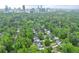 Expansive aerial shot showcasing a neighborhood surrounded by dense trees, with a cityscape visible in the distance at 4005 N Stratford Ne Rd, Atlanta, GA 30342