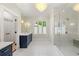 Bathroom featuring double vanities, marble countertops, tiled floors, shower, chandelier and free standing tub at 4005 N Stratford Ne Rd, Atlanta, GA 30342