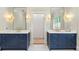 Bathroom featuring double vanities, marble countertops, blue cabinets, tiled floors and gold hardware at 4005 N Stratford Ne Rd, Atlanta, GA 30342