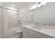 Bright bathroom with marble vanity, modern fixtures, and a tiled shower-tub with crisp white subway tile at 4005 N Stratford Ne Rd, Atlanta, GA 30342