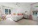 This bedroom boasts neutral colors, carpeting, a large window with curtains, desk, and ceiling fan at 4005 N Stratford Ne Rd, Atlanta, GA 30342
