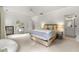 Large, sun-filled bedroom with a seating area, plush carpet, and stylish modern finishes at 4005 N Stratford Ne Rd, Atlanta, GA 30342