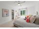This bedroom features neutral colors, carpeting, a large window with curtains, and is brightly lit at 4005 N Stratford Ne Rd, Atlanta, GA 30342