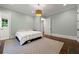 Light-filled bedroom with light-blue walls, wood floors, a double-hung window, and modern lighting at 4005 N Stratford Ne Rd, Atlanta, GA 30342