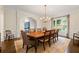 Elegant dining room featuring a chandelier, hardwood floors, and ample natural light at 4005 N Stratford Ne Rd, Atlanta, GA 30342