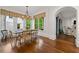 Elegant dining room featuring hardwood floors, a rustic table, and large windows with backyard views at 4005 N Stratford Ne Rd, Atlanta, GA 30342
