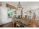 Dining room with rustic table, hardwood floors and natural light, adjacent to a gourmet kitchen at 4005 N Stratford Ne Rd, Atlanta, GA 30342