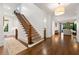 Spacious entryway with hardwood floors, a staircase with wood and wrought iron, and views into the living room at 4005 N Stratford Ne Rd, Atlanta, GA 30342