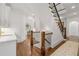 Welcoming entryway with hardwood floors, staircase, and views into the beautifully designed kitchen at 4005 N Stratford Ne Rd, Atlanta, GA 30342