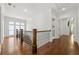 Bright hallway boasts hardwood floors, staircase with dark wood banister, and natural light through the transom window at 4005 N Stratford Ne Rd, Atlanta, GA 30342