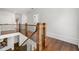Hallway landing with hardwood floors and decorative wood railing at 4005 N Stratford Ne Rd, Atlanta, GA 30342