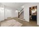Hallway with wood plank walls, staircase, and access to a beautifully decorated half bathroom at 4005 N Stratford Ne Rd, Atlanta, GA 30342