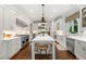 Bright, white kitchen featuring an island with seating, stainless appliances, and a window with patterned valance at 4005 N Stratford Ne Rd, Atlanta, GA 30342