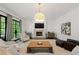 Bright living room with large windows, stone fireplace, hardwood floors, and comfortable seating at 4005 N Stratford Ne Rd, Atlanta, GA 30342
