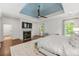 The airy main bedroom features a fireplace, neutral colors, ceiling fan, hardwood floors and large windows at 4005 N Stratford Ne Rd, Atlanta, GA 30342