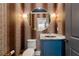 Chic powder room with patterned wallpaper, an ornate mirror, and a blue vanity with marble countertop at 4005 N Stratford Ne Rd, Atlanta, GA 30342