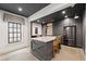 Stylish wet bar featuring dark gray cabinetry, stainless steel appliances, and a marble countertop at 4005 N Stratford Ne Rd, Atlanta, GA 30342