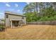 A spacious backyard with a well-manicured lawn and a cozy covered patio area, perfect for outdoor relaxation at 821 Ethereow Ct, Lawrenceville, GA 30046