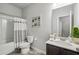 Well-lit bathroom with white tiles, a patterned shower curtain, and updated fixtures at 821 Ethereow Ct, Lawrenceville, GA 30046