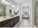 Bathroom featuring double vanity, granite countertops, and walk-in shower, designed for comfort and luxury at 821 Ethereow Ct, Lawrenceville, GA 30046