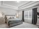 Serene bedroom with tray ceilings, neutral tones, and plenty of natural light at 821 Ethereow Ct, Lawrenceville, GA 30046